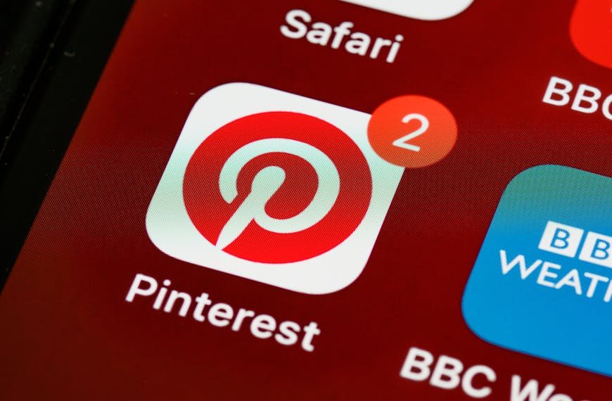 Close-up of Pinterest app icon and notifications on a smartphone screen, detailed and vibrant technologically themed image.